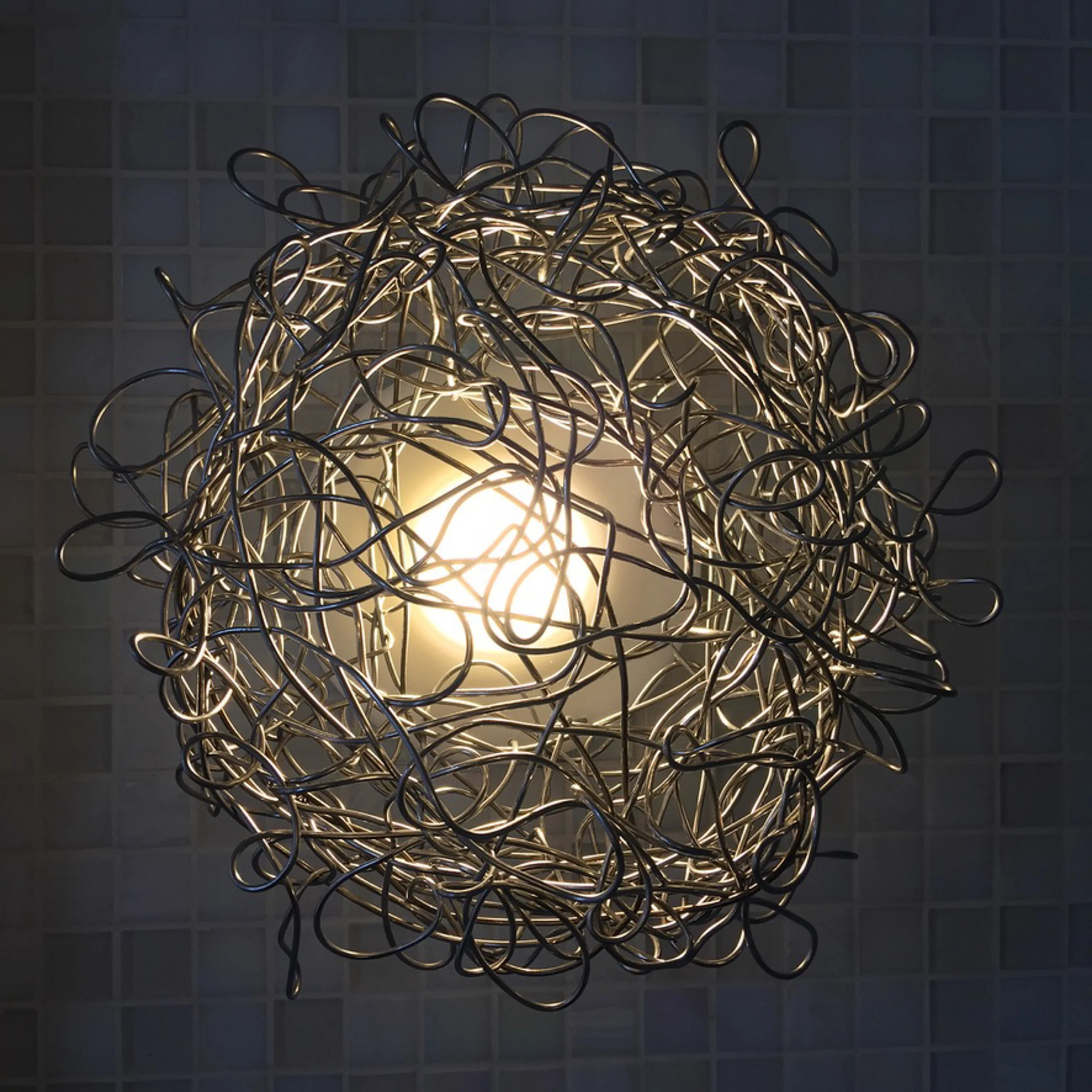 Hand-formed steel wire light lit